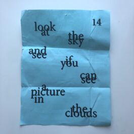 Blue piece of paper with overlapping words 