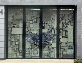 Large industrial windows covered in clear and white plastic images