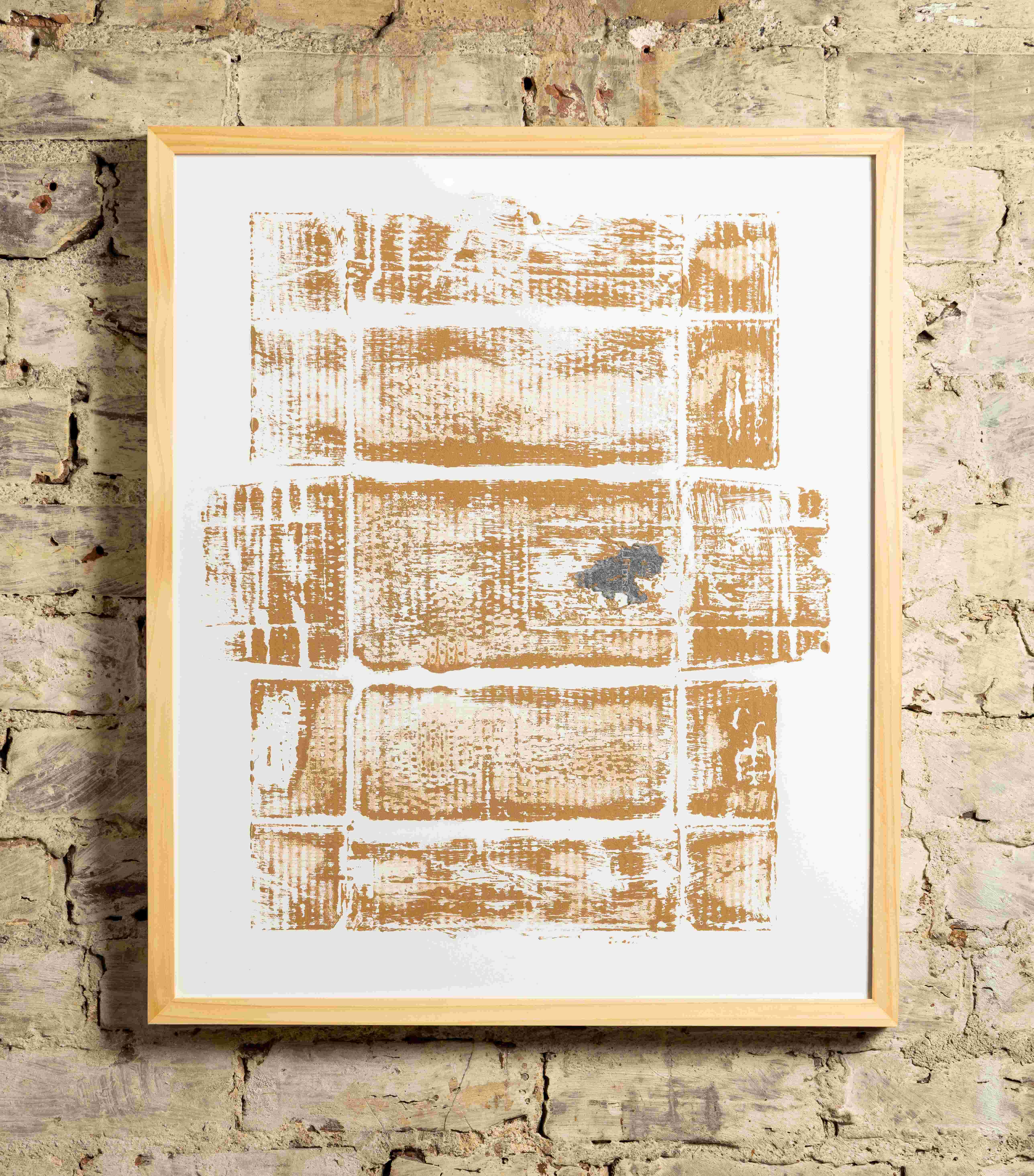 Framed print of a cardboard box on an exposed brick wall